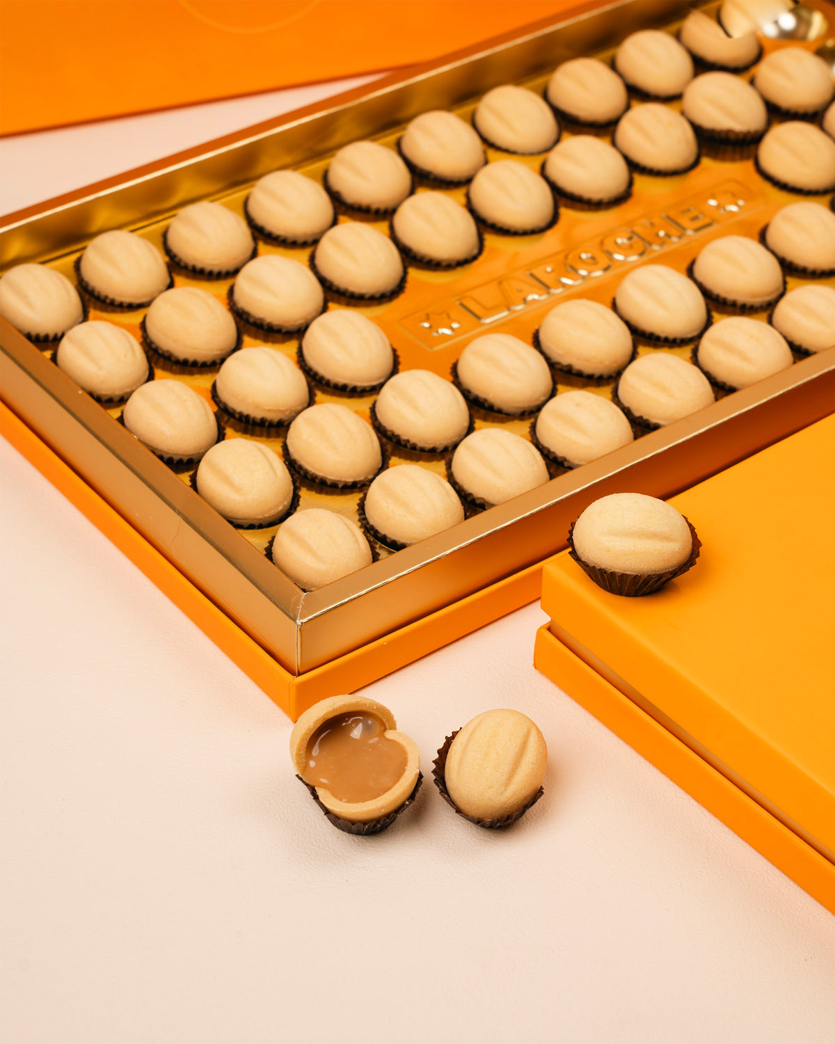 Premium Ain Al Jamal sweets from Laroche in luxury orange packaging